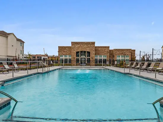 A large swimming pool with a lot of chairs around it