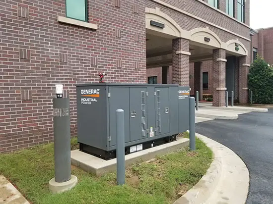 A large electrical box sitting in front of a building.